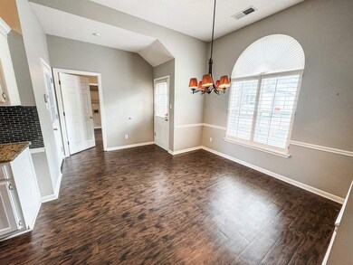 Unfurnished dining area with dark wood-style floor