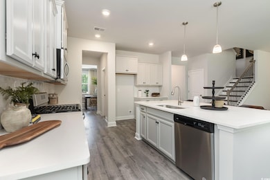 Kitchen featuring light countertops, appliances wi