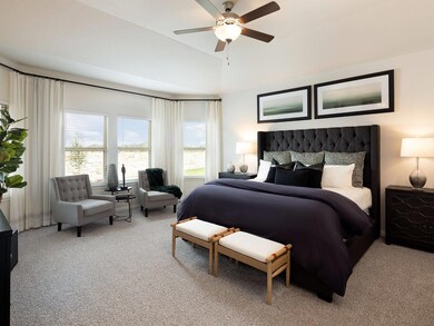 Bedroom featuring light carpet, multiple windows,