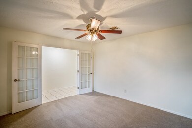 From the opposite corner of the office we can see the stunning French doors w/ accenting door levers allowing the space to be closed off from any rustle & bustle of the home.