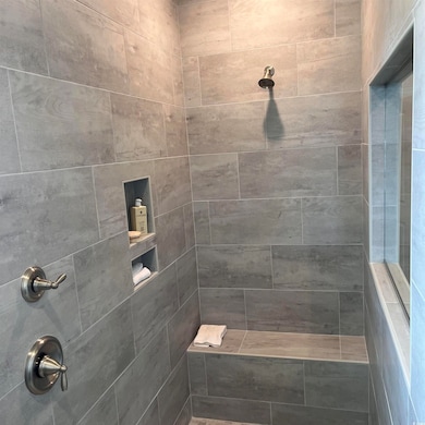 Full bathroom with tiled shower