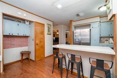 Kitchen featuring wood finished floors, ornamental