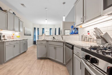 Kitchen featuring gray cabinetry, appliances with 
