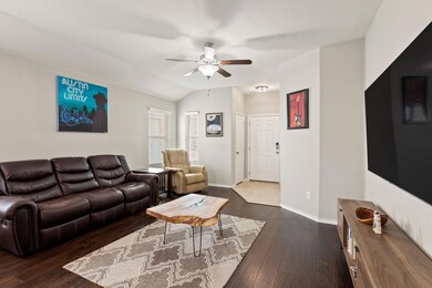 Living room with a ceiling fan, dark wood-style f