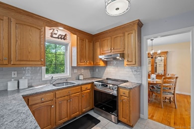 The kitchen has newer appliances, granite counters and storage.