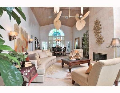 Living Room - Coral Stone Floors and Fireplace with Vaulted Wood Ceilings.