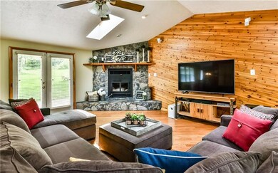 Light and bright living room features vaulted ceil