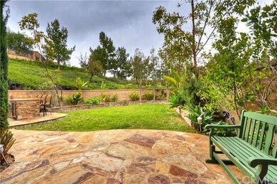 Boasting custom hardscape including stone patios, 