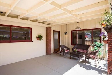 Lighted front patio with lovely front door facing 