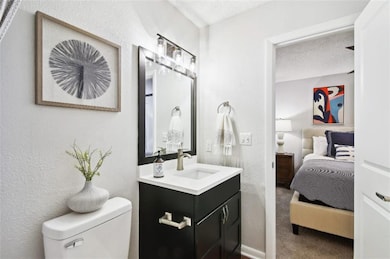 Bathroom with oversized vanity, toilet, and a text