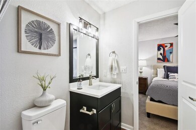Bathroom with oversized vanity, toilet, and a text