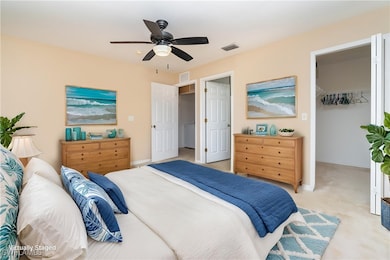 Bedroom featuring a walk in closet, baseboards, li