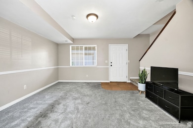 Unfurnished living room featuring carpet and tile patterned floors