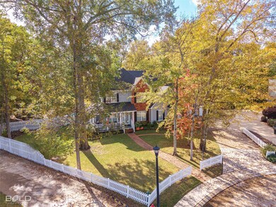 View of front of property with a fenced front yard, covered porch, and view of scattered trees