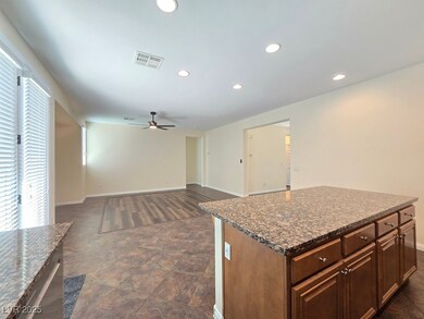 Kitchen with a ceiling fan, baseboards, recessed l