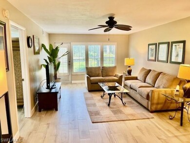 Living room with light wood finished floors and a ceiling fan