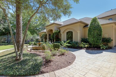 ANOTHER VIEW OF THE GRAND EXTERIOR ENTRY - classic style stucco exterior enhanced with stone accents