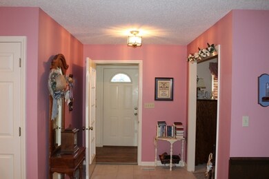 Enclosed Entry with wood flooring and coat closet 