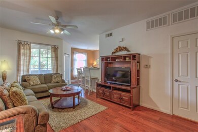 Living room with ceiling fan and wood finished flo
