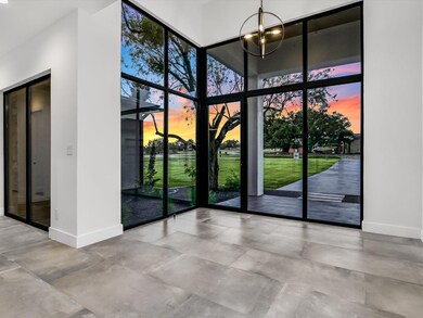 Doorway to outside a notable chandelier, and a hig