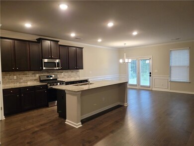 Kitchen featuring a kitchen island with sink, a si