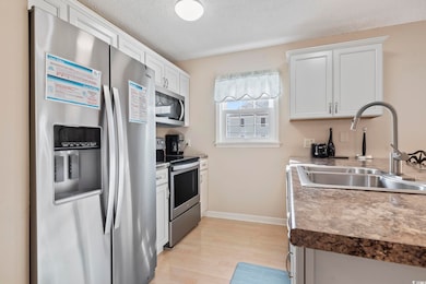 Kitchen with white cabinetry, stainless steel appl