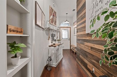 Custom wood accent wall. Bookcase on left opens to reveal hidden closet/ safe.