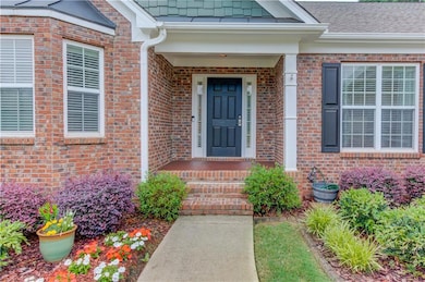 View of exterior entry featuring brick siding