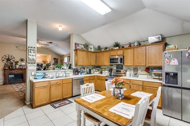 Kitchen featuring sink, ceiling fan, stainless ste