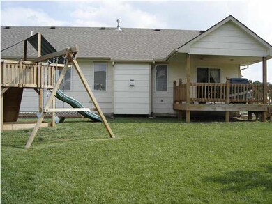 Back view with covered deck for entertaining and c
