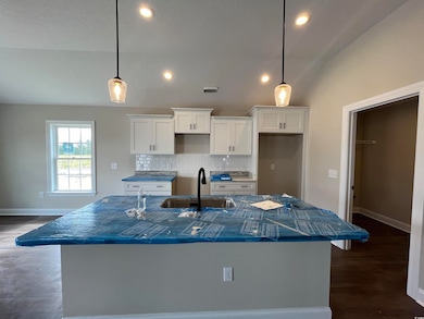 Kitchen with lofted ceiling, hanging light fixture