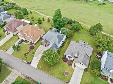 Aerial view of residential area featuring a golf course