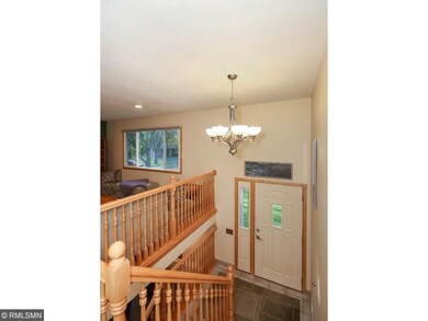 Ceramic tiled foyer and Maple wood railing system.