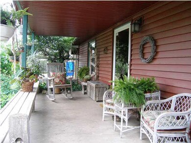 The covered front porch shelters and provides grea