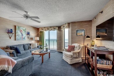 Living room featuring dark carpet, a textured ceil