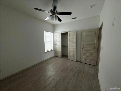 Unfurnished bedroom featuring visible vents, wood finished floors, a closet, baseboards, and ceiling fan