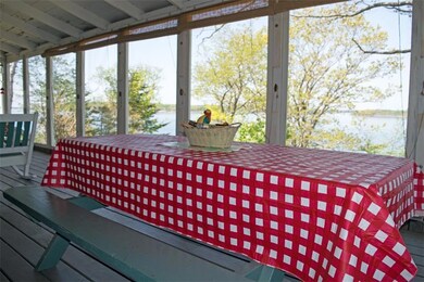 The large screened-in porch with the...