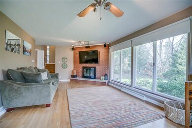 Another view of the living room, fireplace and lar