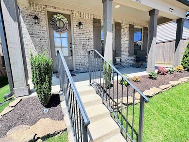 Entrance to property featuring brick siding and a porch