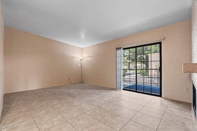 Unfurnished room with light tile patterned floors