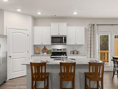 sudbury townhome kitchen with white cabinets and g