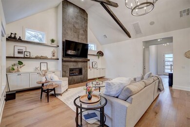 Living room with a tile fireplace, light wood-type