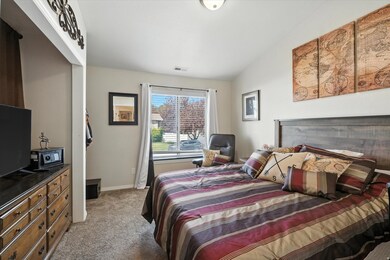 Bedroom with light colored carpet and lofted ceiling. Great office location with French doors into front living room.