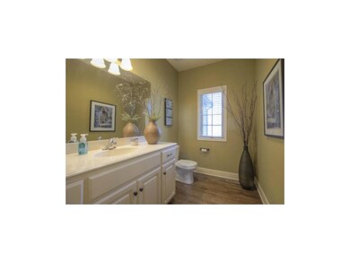 The hall bath is adjacent to the entryway & offers