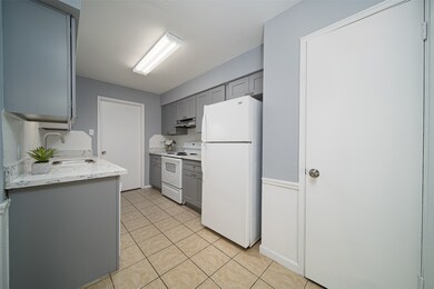 Kitchen with updated cabinet and quartz countertops.