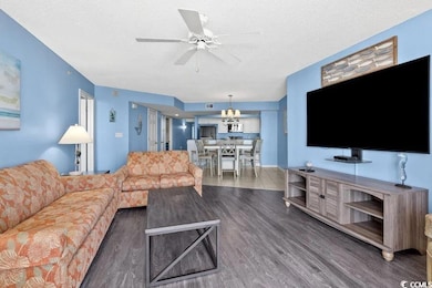 Living area featuring dark wood finished floors, a