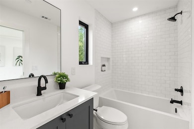 Full bath featuring toilet, vanity, tub / shower 
