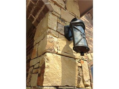 Exterior Front. Arched Stacked stone entry, flanke