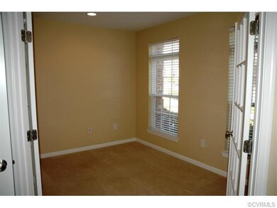 French doors lead to an office with large walk in 