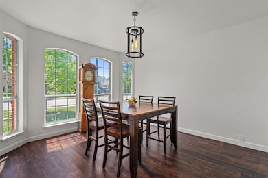 Dining space with baseboards and dark wood-style 